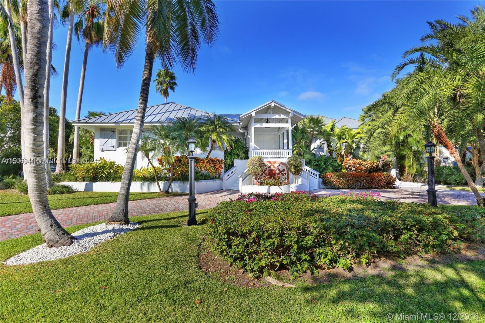 390 Gulf Road Key Biscayne, FL 33149 - Photo 3 of 25 a front view of a house with a yard