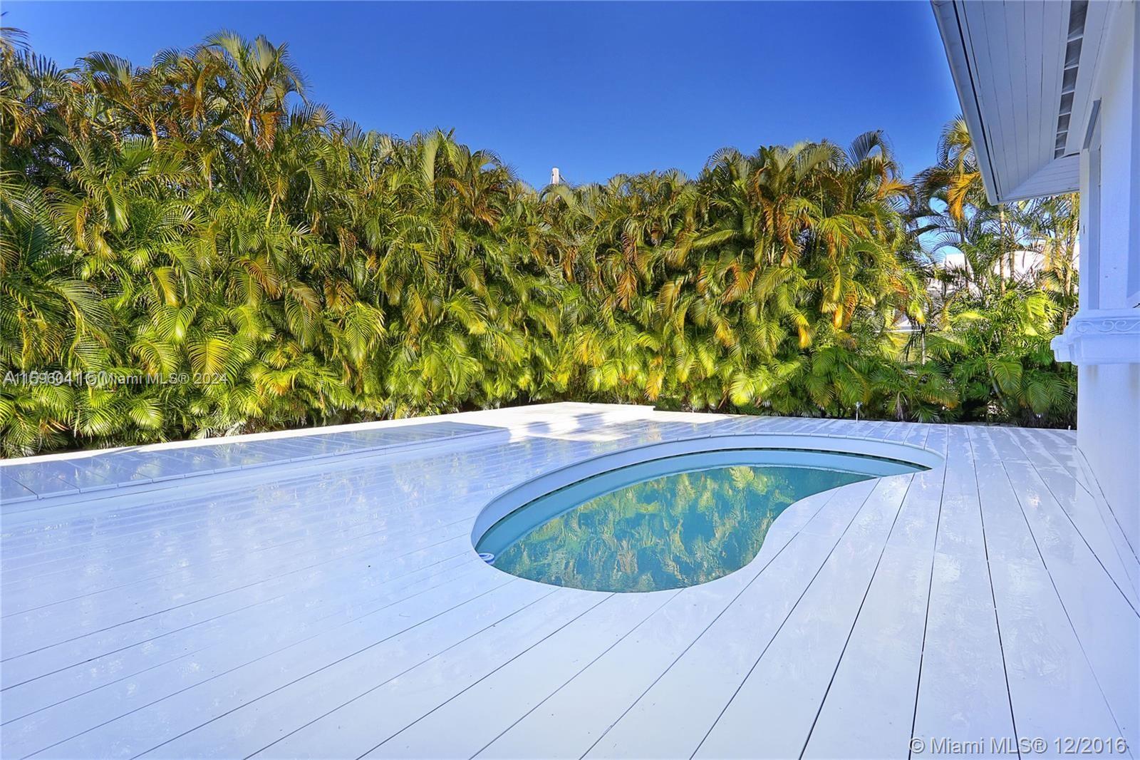 390 Gulf Road Key Biscayne, FL 33149 - Photo 6 of 25 a view of a swimming pool with a yard