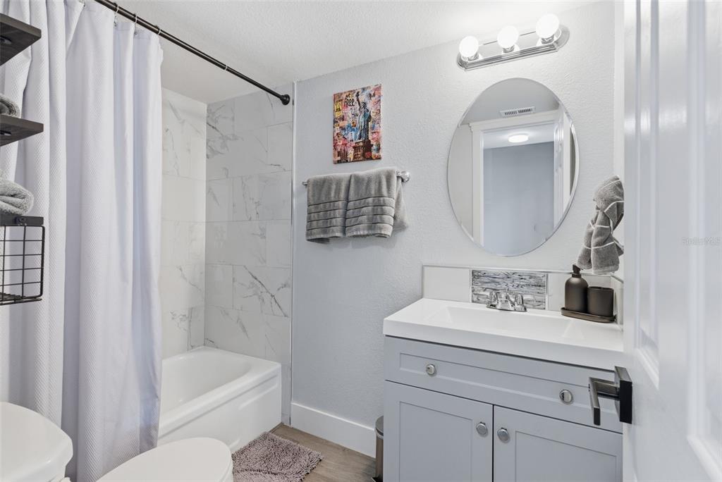 631 North Keene Road, Unit S8 Clearwater, FL 33755 - Photo 14 of 20 a bathroom with a sink a toilet and a bathtub