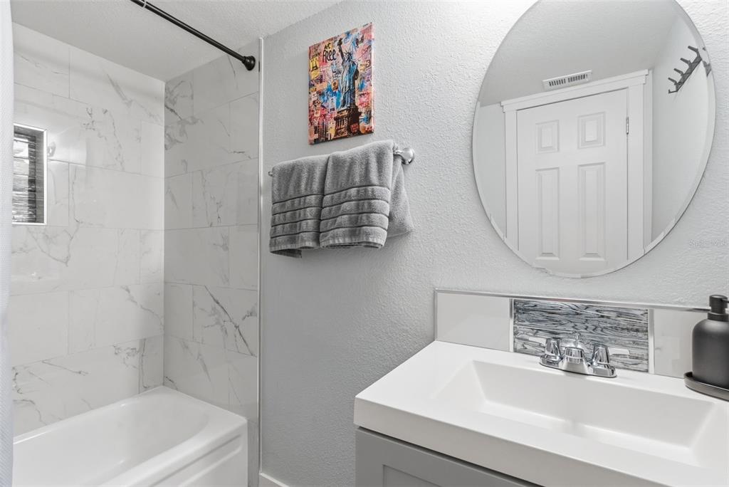 631 North Keene Road, Unit S8 Clearwater, FL 33755 - Photo 15 of 20 a bathroom with a sink a mirror and a bathtub