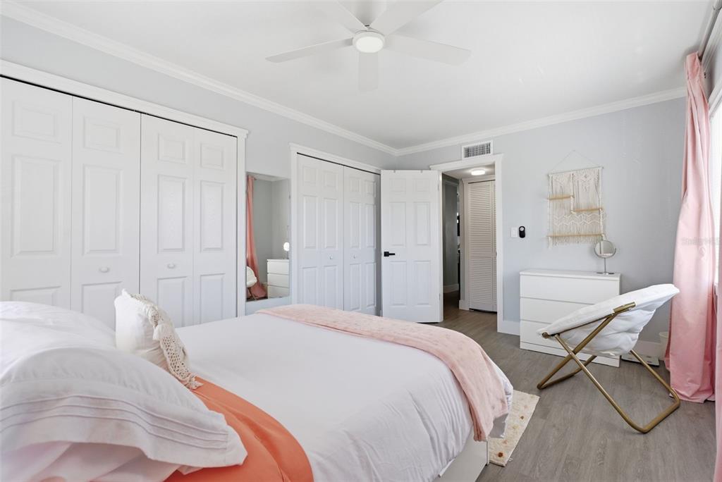 631 North Keene Road, Unit S8 Clearwater, FL 33755 - Photo 17 of 20 a spacious bedroom with a bed and a table in it