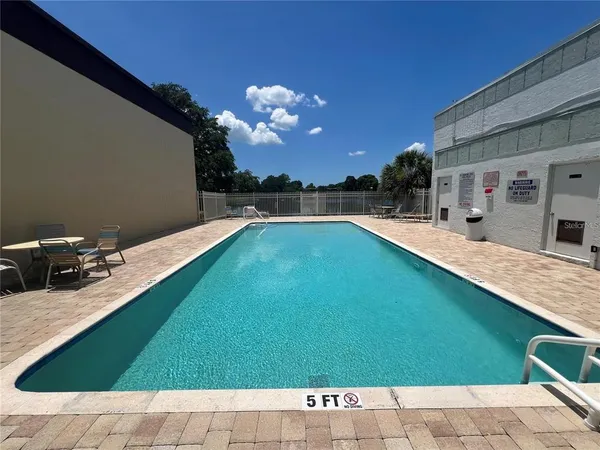 a view of a swimming pool with an outdoor space and seating area