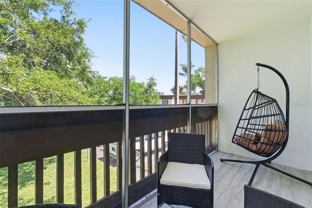 631 North Keene Road, Unit S8 Clearwater, FL 33755 - Photo 19 of 20 a view of a chairs and table in wooden balcony