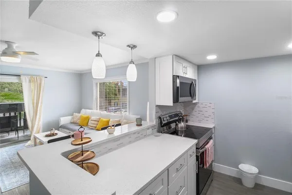 a kitchen with stainless steel appliances a sink a refrigerator and cabinets
