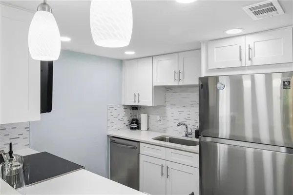 a kitchen with stainless steel appliances a stove a sink and a microwave