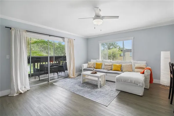 a living room with furniture and kitchen view