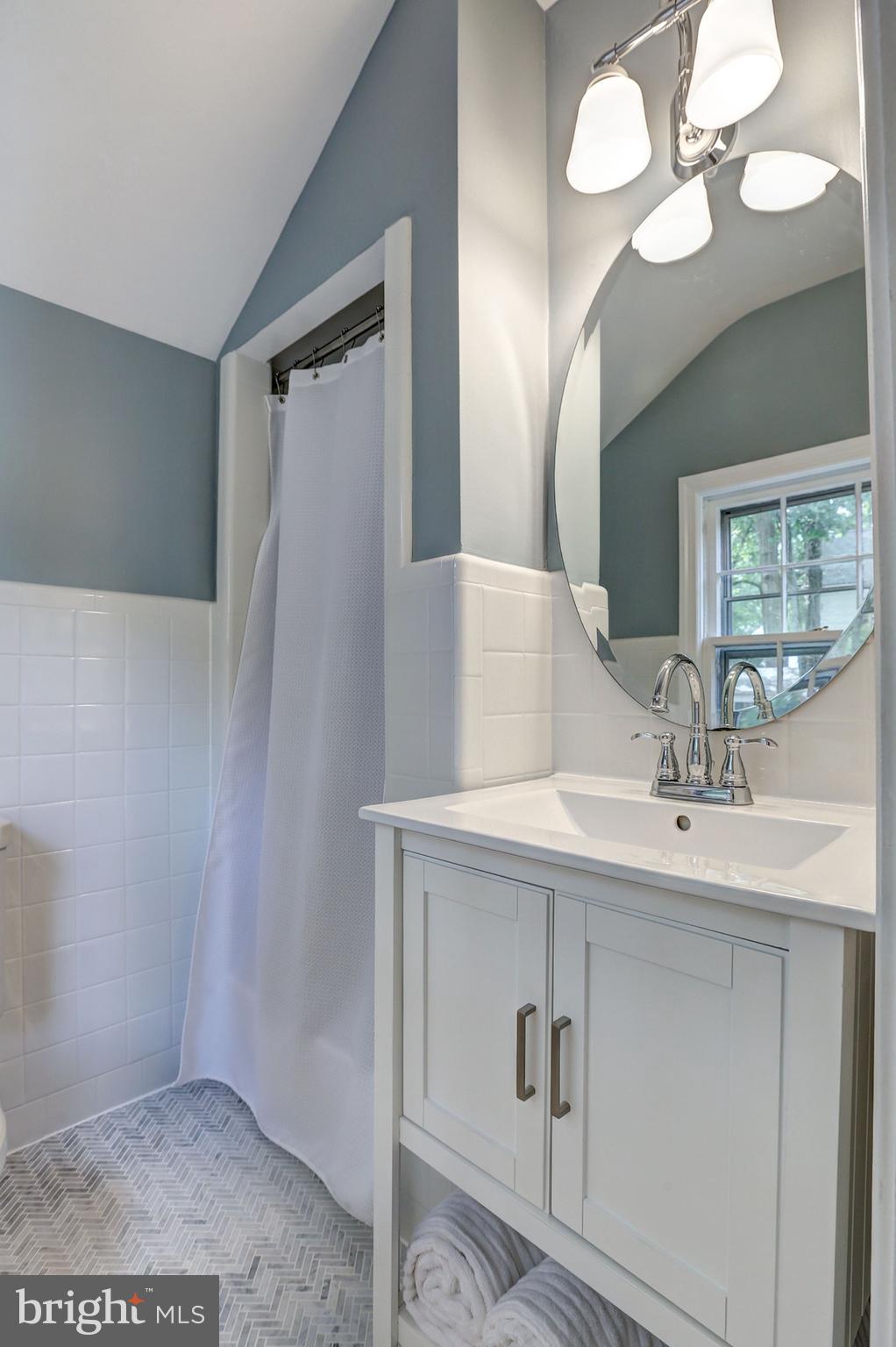 5908 Gloster Road Bethesda, MD 20816 - Photo 21 of 40 Owner's bath with herringbone Carrera floors