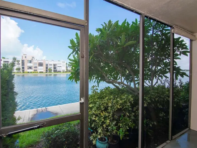 a view of a swimming pool and lounge chairs in patio