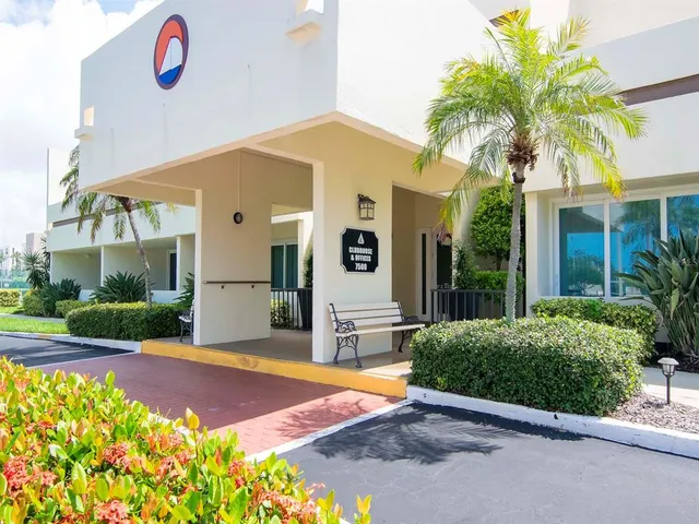 a view of a house with backyard and patio