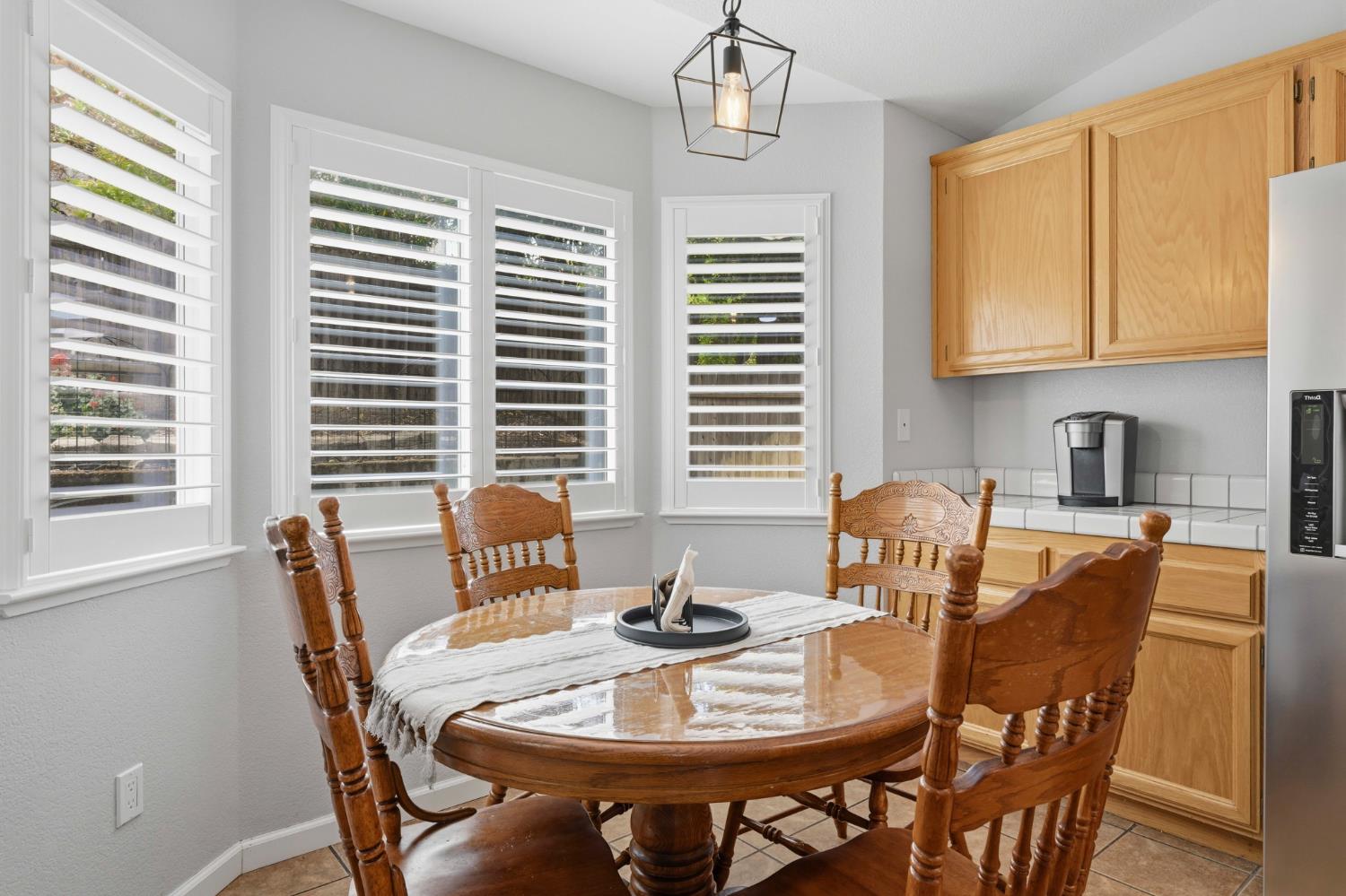5013 Charter Road Rocklin, CA 95765 - Photo 16 of 35 a view of a dining room with furniture windows and wooden floor