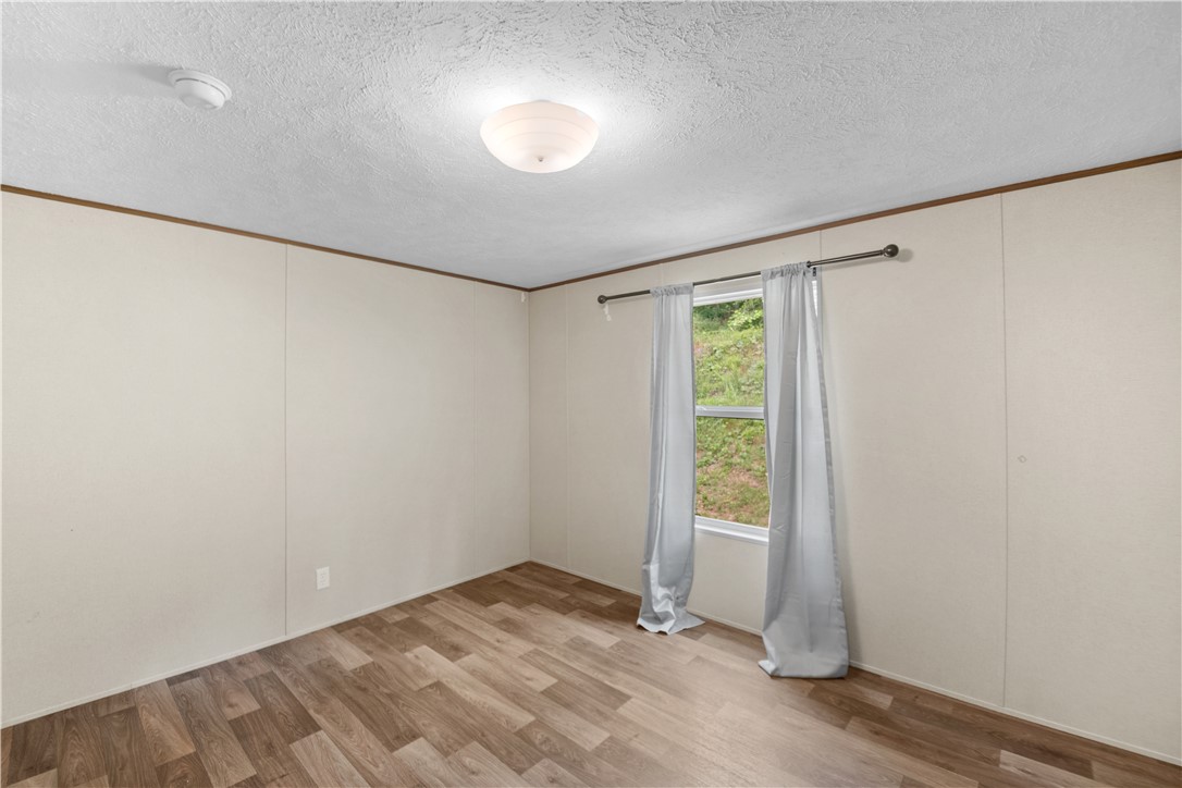 1188 Old Liberty Road Easley, SC 29640 - Photo 22 of 28 This spacious room offers versatile living with durable flooring and natural light.