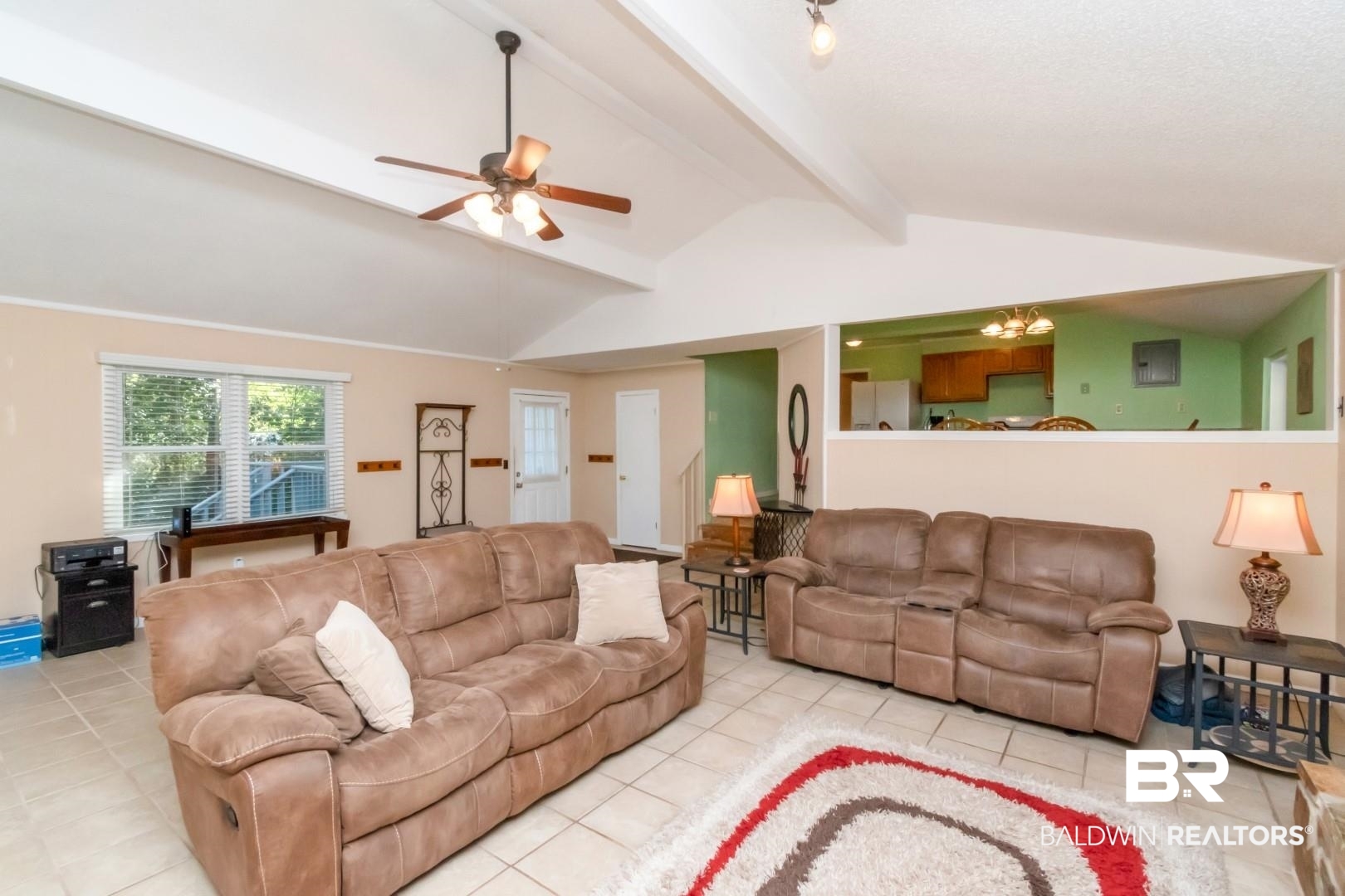 1321 Rainbow Drive West Mobile, AL 36693 - Photo 19 of 48 Tiled living room with vaulted ceiling with beams and ceiling fan with notable chandelier
