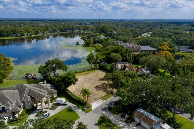 an aerial view of a house with a lake view