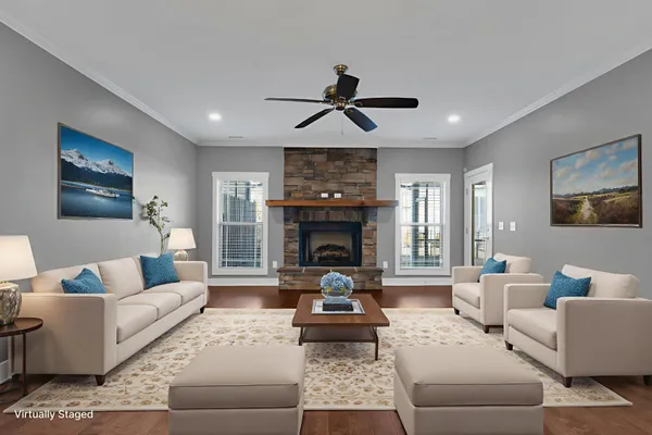 a living room with furniture large window and a fireplace