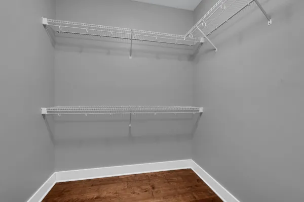a view of walk in closet with empty racks