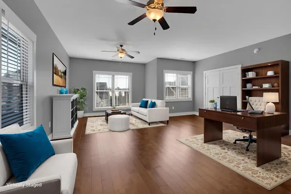 a living room with furniture and wooden floor