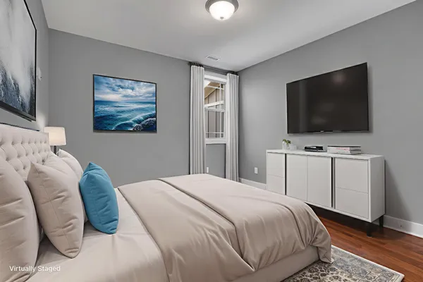 a bedroom with a flat screen tv and a bed