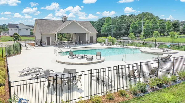 swimming pool view with a seating space