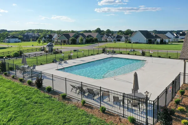 a front view of a house with swimming pool and outdoor seating
