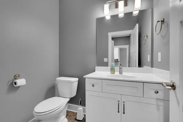 a bathroom with a toilet a sink and mirror