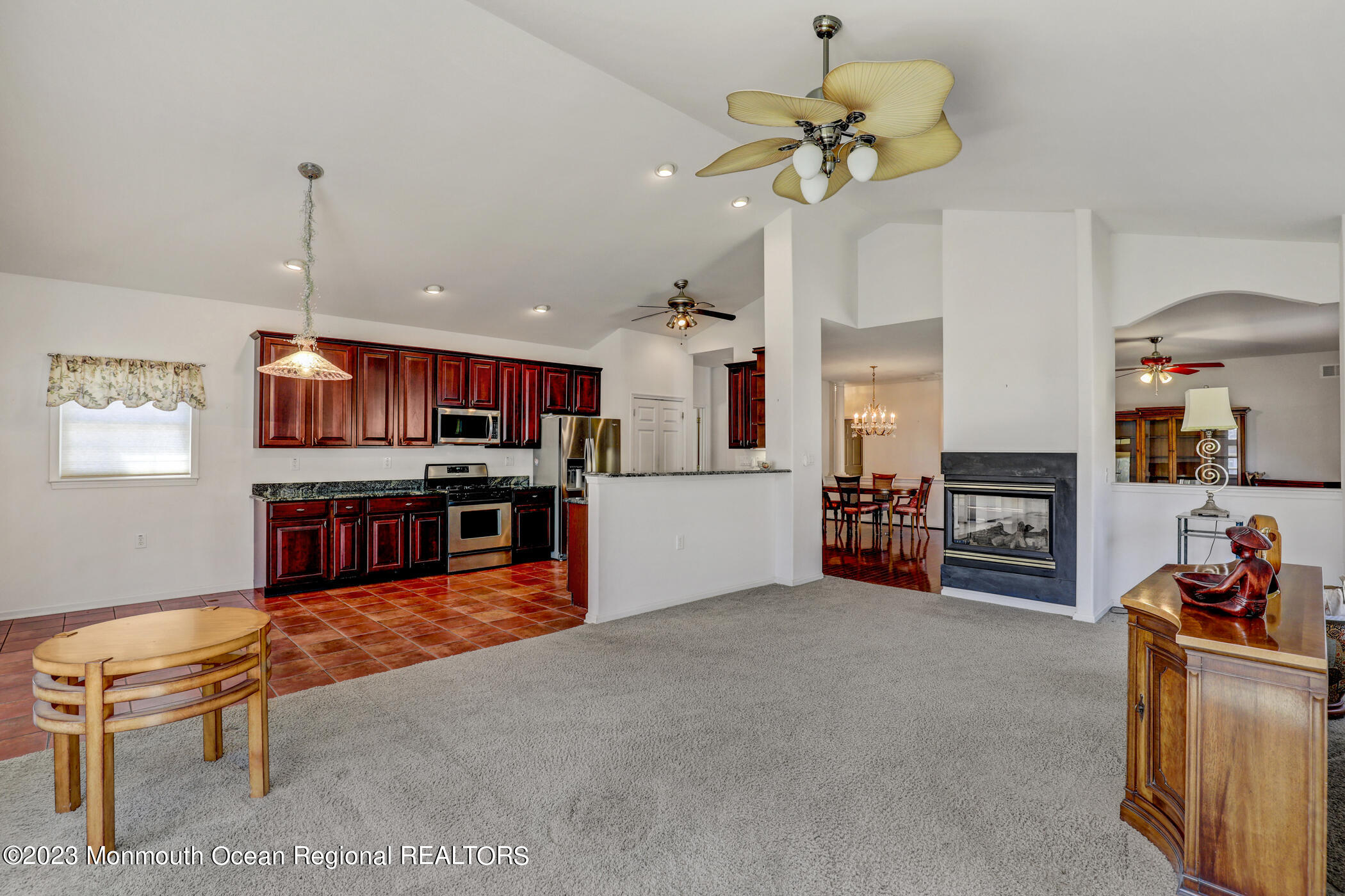 12 Vecchio Road Manchester Township, NJ 08759 - Photo 9 of 35 a living room with fireplace furniture and a chandelier