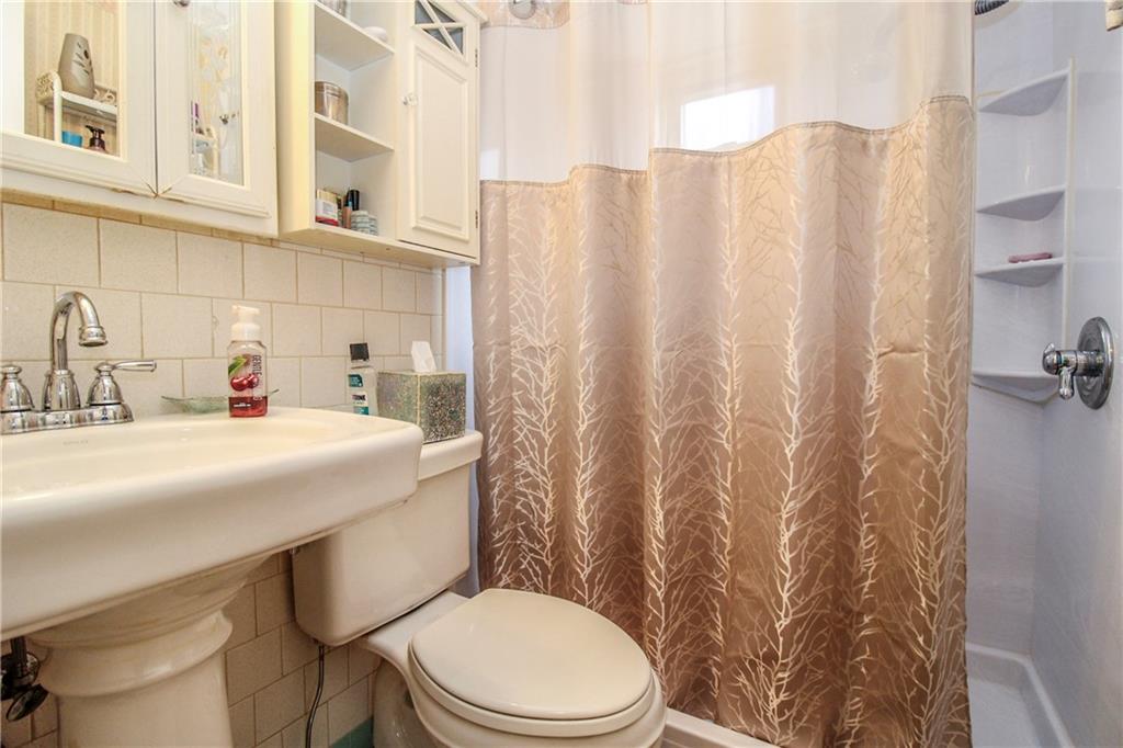 303 Wright Street McKees Rocks, PA 15136 - Photo 12 of 25 Full bath in the main level hallway located next to the first floor bedroom for convenient access.