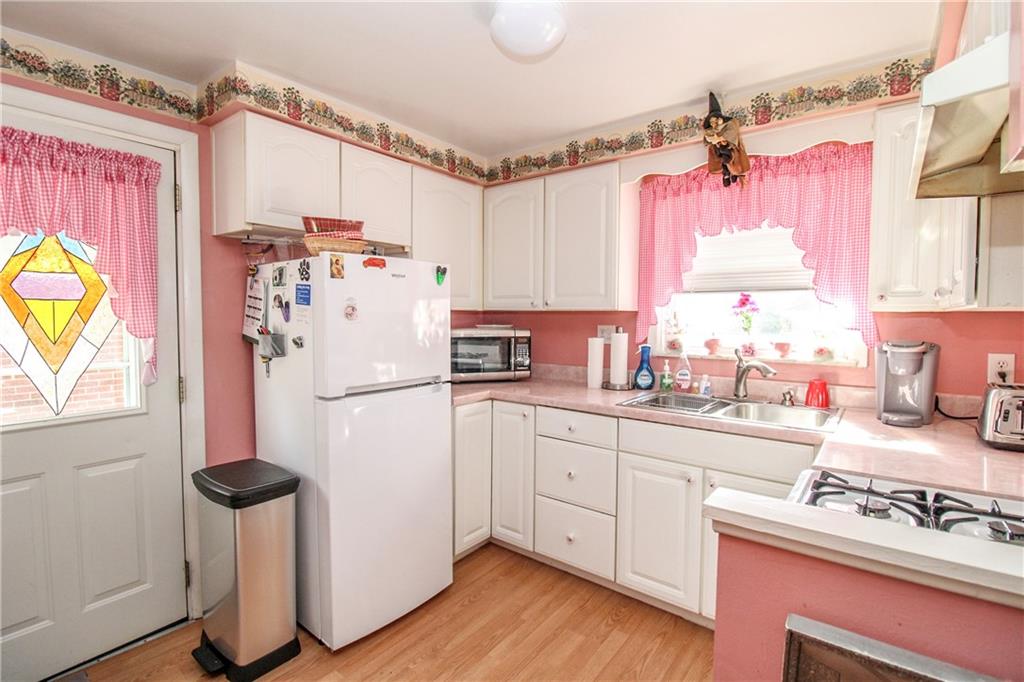 303 Wright Street McKees Rocks, PA 15136 - Photo 9 of 25 Kitchen with white cabinetry & gas cooking.