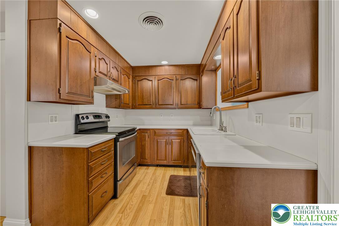 1814 Ruth Street Allentown, PA 18104 - Photo 17 of 54 Rich wood cabinetry paired with light countertops creates a warm, classic culinary workspace.