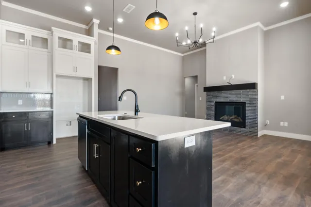 a kitchen with a sink and chandelier