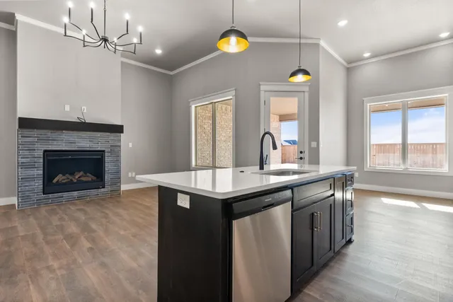 a kitchen with a sink and a stove next to a window