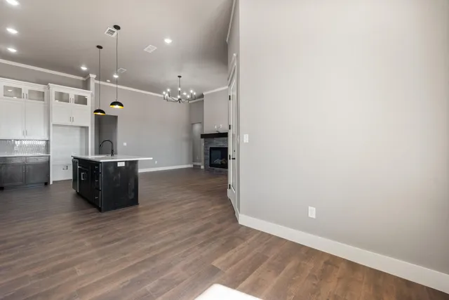 a view of a kitchen with a sink and wooden floor
