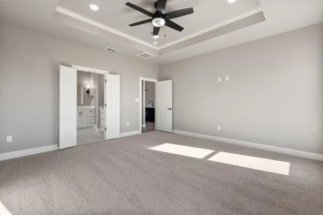 a view of an empty room and kitchen view