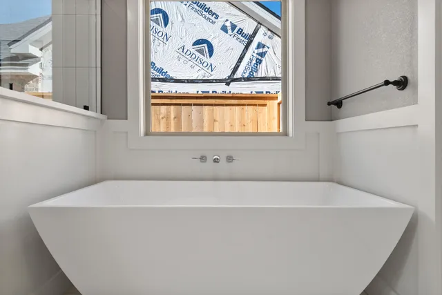 a white bath tub sitting next to a window