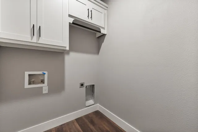 a view of small space with wooden floor and cabinets