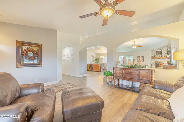 a living room with furniture and kitchen view