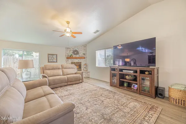 a living room with furniture and a fireplace