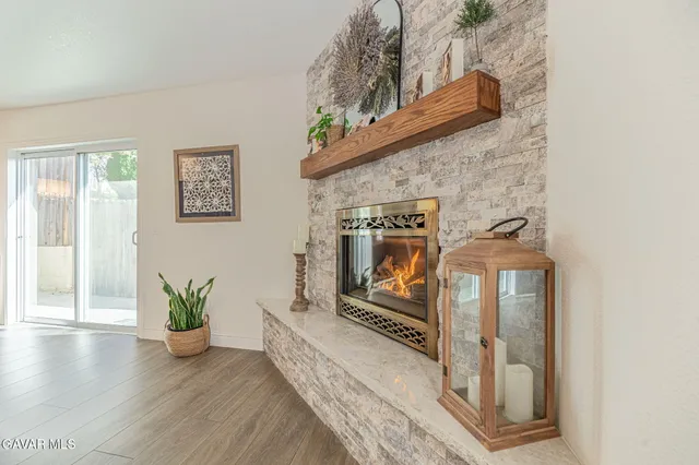 a view of a dining room with furniture a kitchen and chandelier