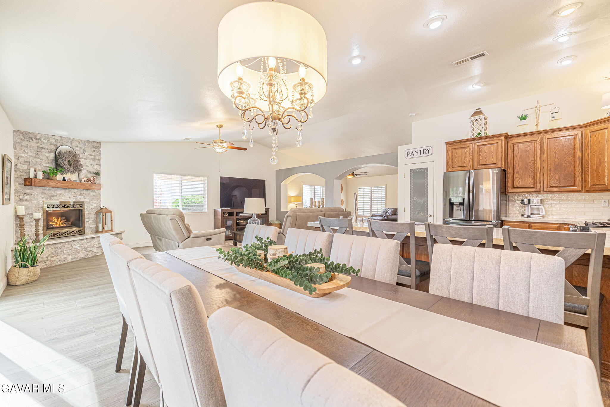 19812 Breeze Place Tehachapi, CA 93561 - Photo 17 of 59 a view of a dining room with furniture a kitchen and chandelier