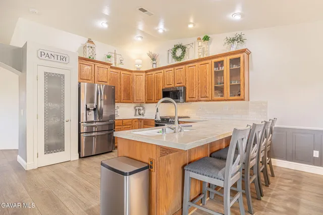 a large white kitchen with stainless steel appliances