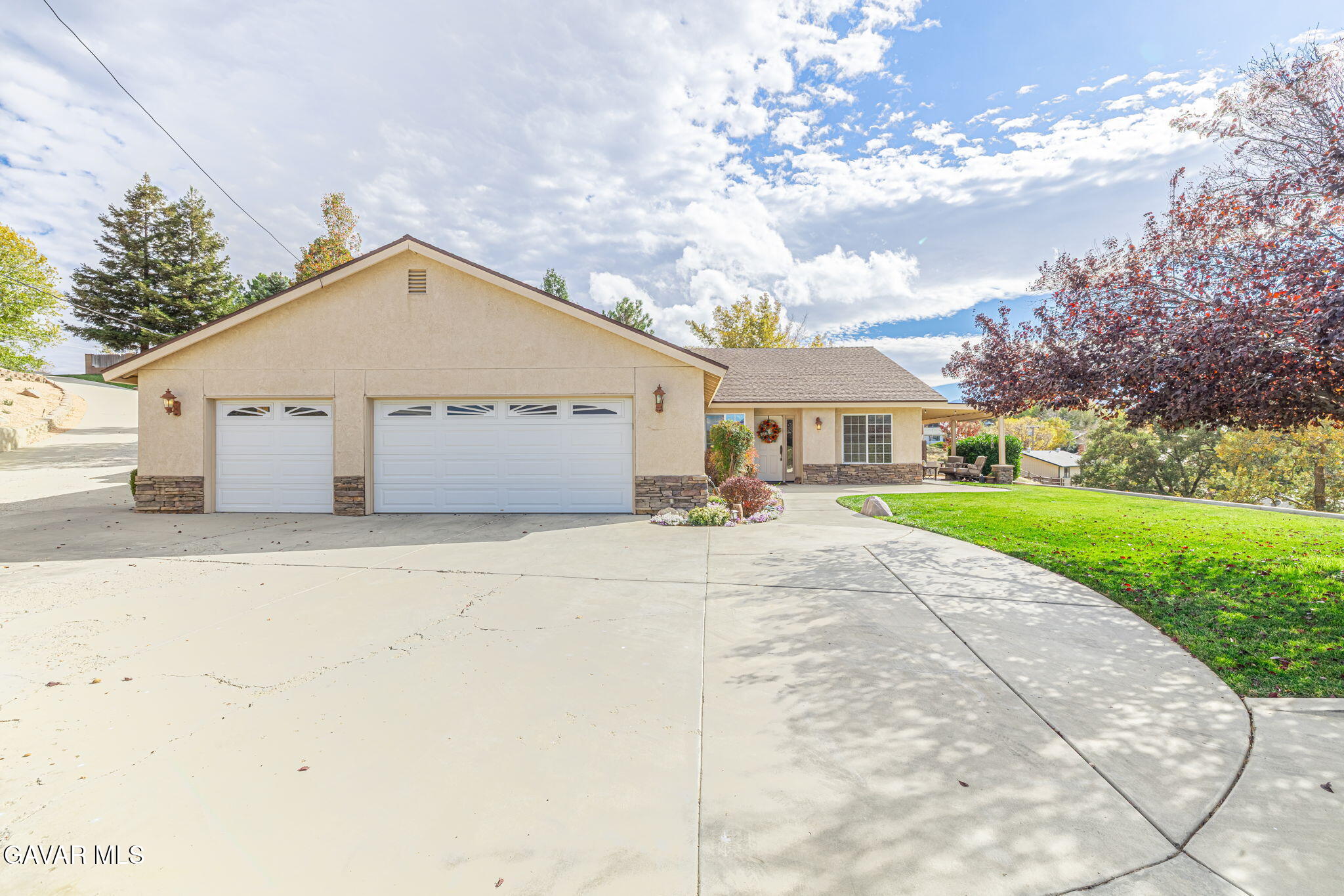 19812 Breeze Place Tehachapi, CA 93561 - Photo 2 of 59 a view of a white house with a yard and large tree