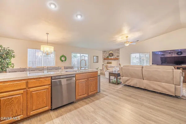 a kitchen with stainless steel appliances granite countertop a refrigerator and a stove top oven