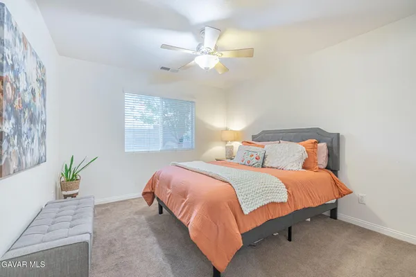 a bedroom with a bed and a dresser