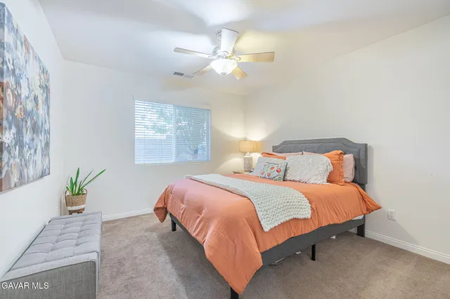 a bedroom with a bed and a dresser