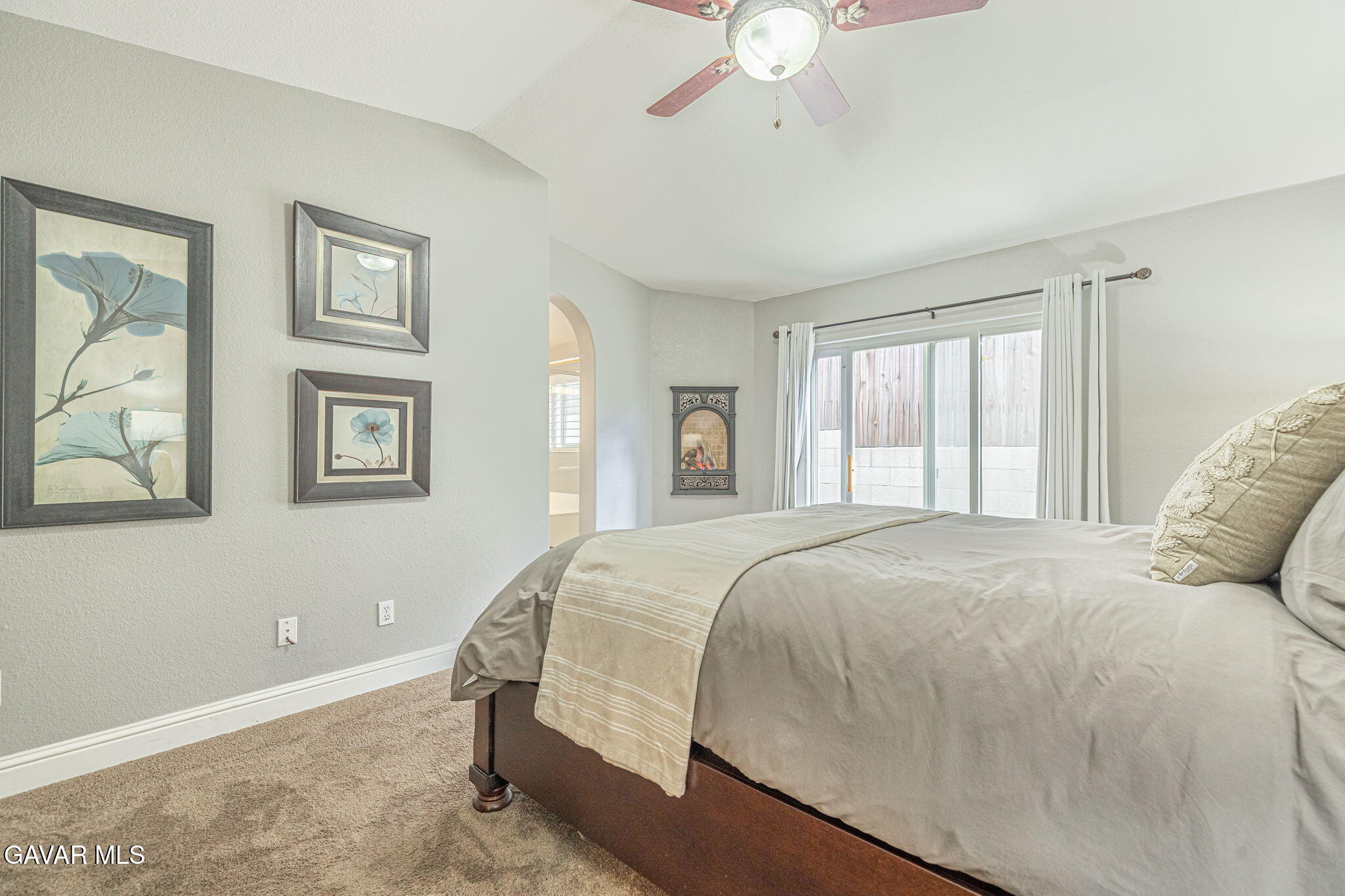 19812 Breeze Place Tehachapi, CA 93561 - Photo 32 of 59 a bedroom with a large bed and a chandelier