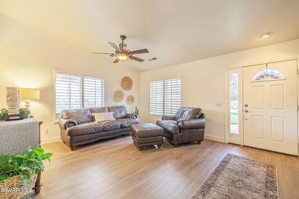 a living room with furniture a flat screen tv and a table