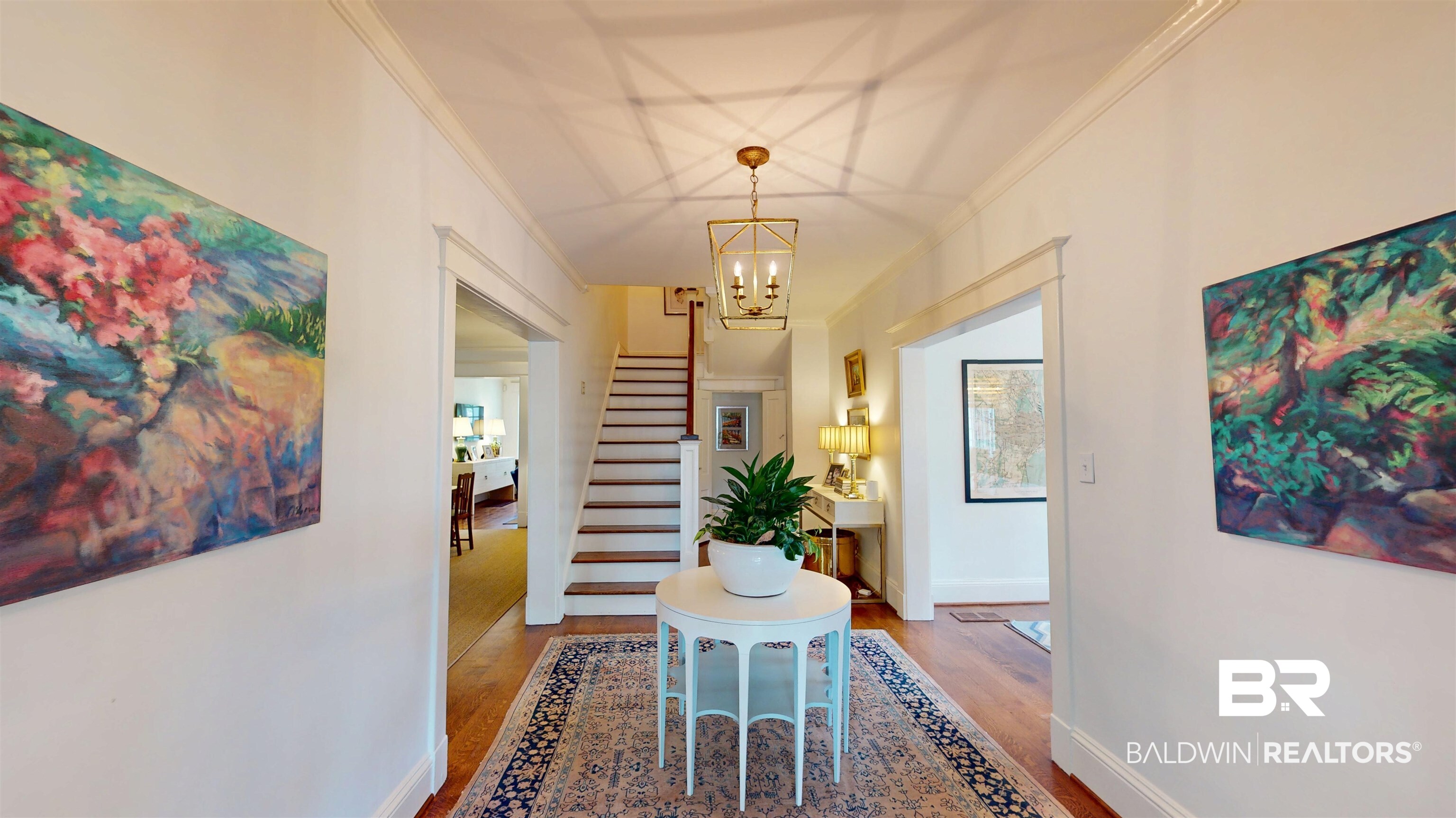 211 Lanier Avenue Mobile, AL 36607 - Photo 7 of 73 Hall with crown molding, wood finished floors, a chandelier, and stairway