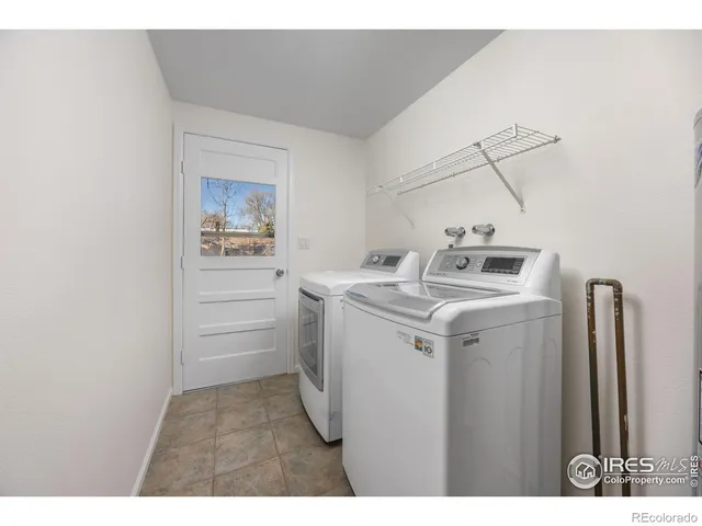 a backyard of a house with large trees and outdoor seating
