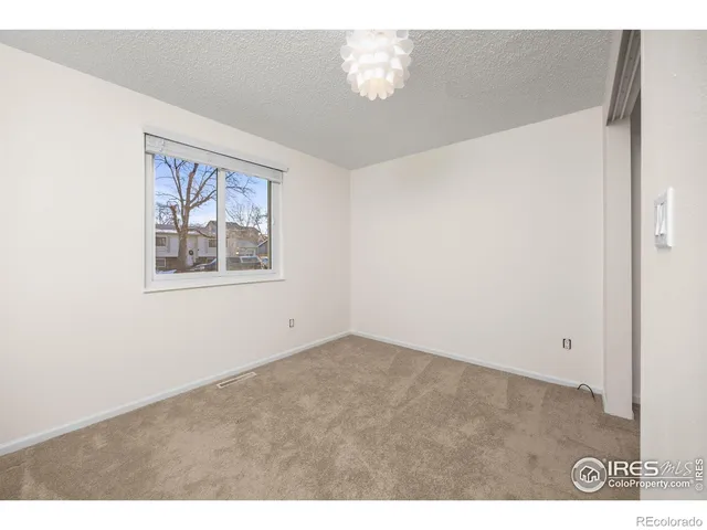 a view of an empty room and a window
