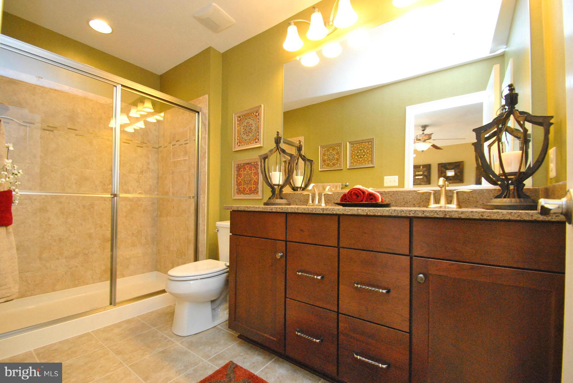 937 Ramble Run Road Middle River, MD 21220 - Photo 16 of 21 a bathroom with a toilet a sink and mirror