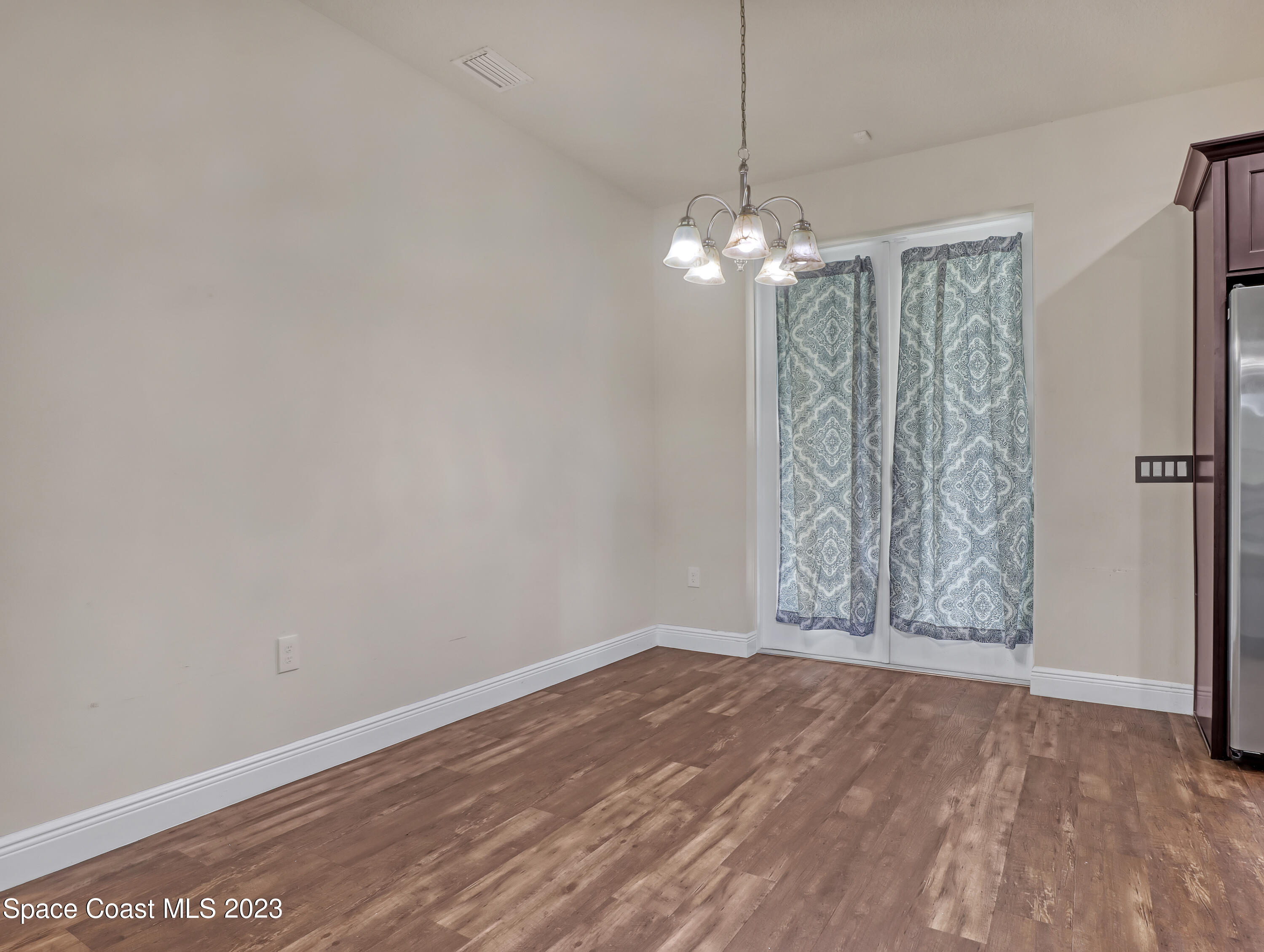 1310 Gaucho Road Southwest Palm Bay, FL 32908 - Photo 11 of 32 a view of entryway with wooden floor